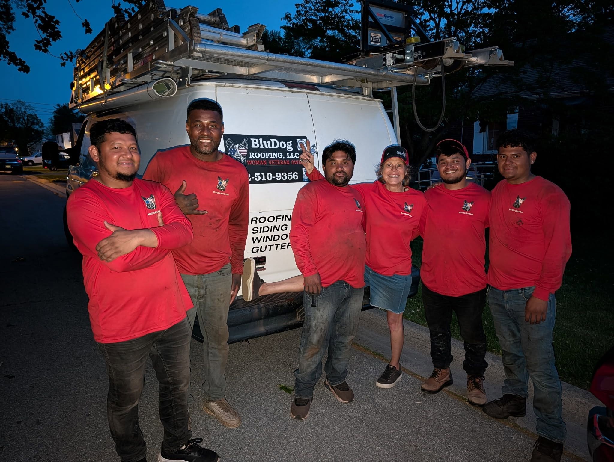 BluDog Roofing team photo in matching red shirts